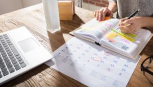 Time management: Person organising calendar and schedule
